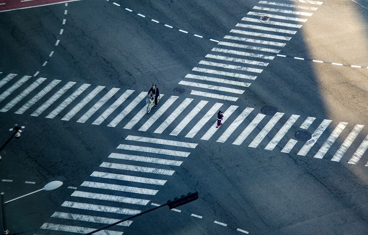 Zebra crossings and dashed road markings at a junction, seen from directly above